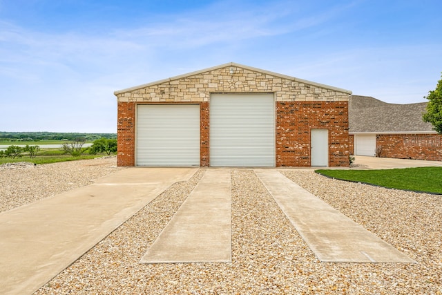 view of front of property with an outdoor structure and a garage