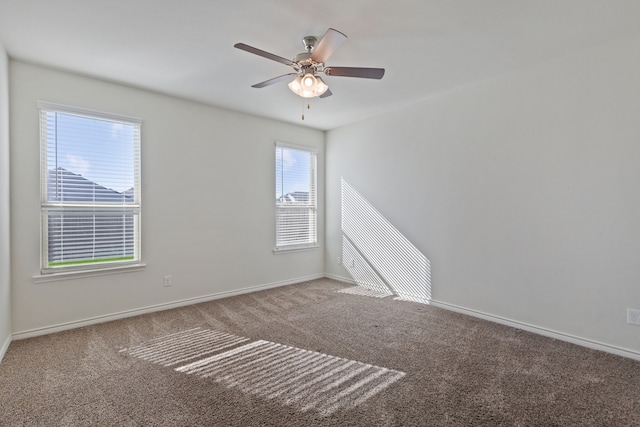 spare room featuring ceiling fan and carpet floors