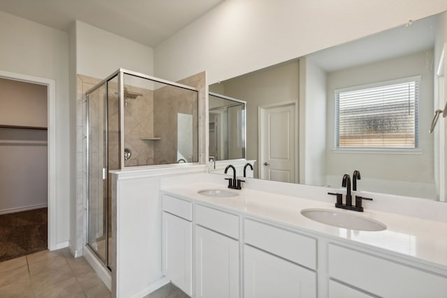 bathroom featuring tile patterned flooring, vanity, and an enclosed shower