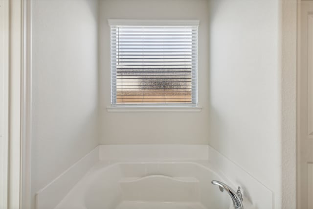 bathroom with a tub to relax in