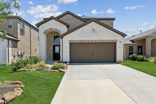 view of front of home with a garage and a front yard