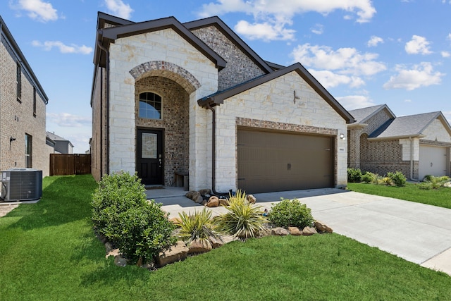 view of front of property featuring a front yard, a garage, and cooling unit