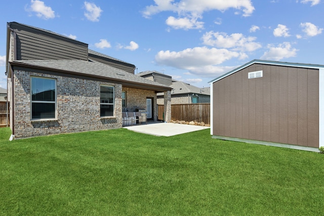 back of property with a yard, a storage unit, and a patio area