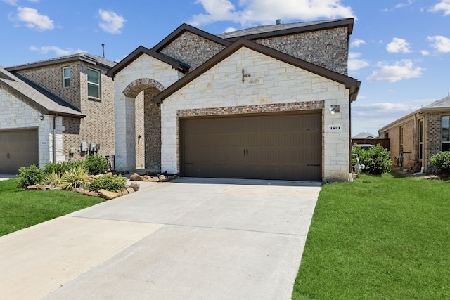 view of front of house with a garage and a front lawn