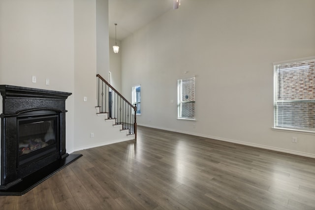 living room with dark hardwood / wood-style floors and high vaulted ceiling