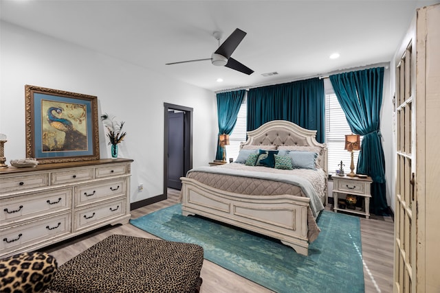 bedroom with ceiling fan and light hardwood / wood-style floors