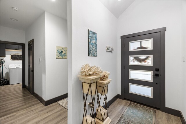 foyer with hardwood / wood-style flooring, plenty of natural light, and washer / clothes dryer