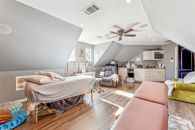 bedroom with ceiling fan, hardwood / wood-style floors, lofted ceiling, and sink