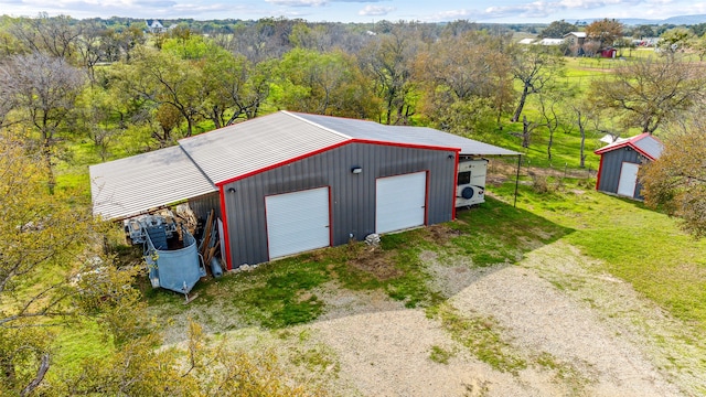 exterior space featuring ac unit and a garage