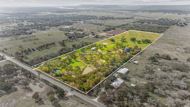 birds eye view of property with a rural view