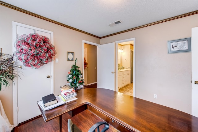 office area with a textured ceiling, light wood-type flooring, and crown molding