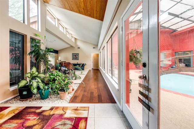 hallway featuring hardwood / wood-style floors and high vaulted ceiling