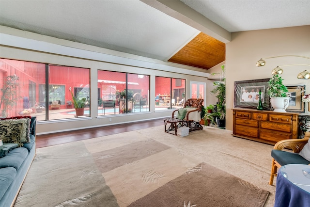 living room featuring lofted ceiling with beams, a textured ceiling, and hardwood / wood-style flooring