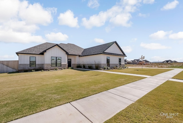 modern farmhouse style home with a front yard