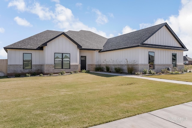 modern inspired farmhouse featuring a front yard and a garage