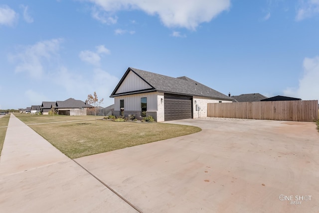 view of front of home with a front lawn and a garage