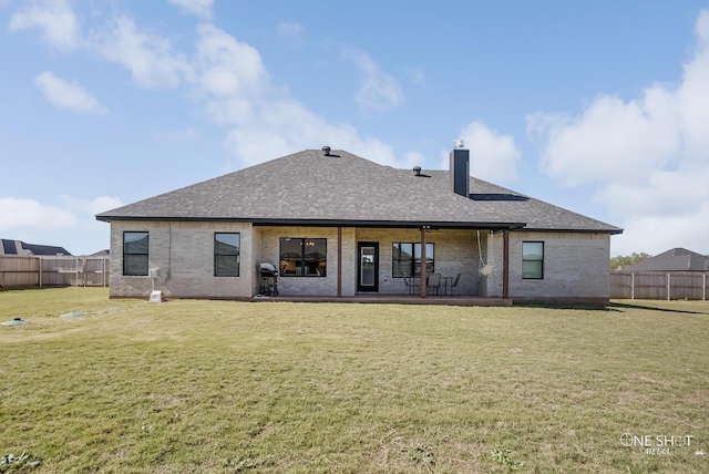 back of property featuring a yard and a patio