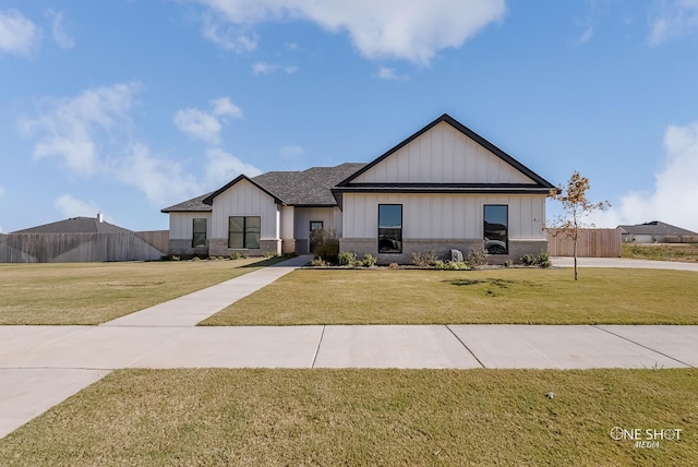 modern inspired farmhouse with a front lawn