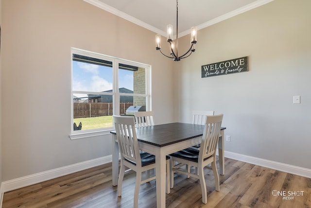 dining room featuring hardwood / wood-style floors, a chandelier, and ornamental molding