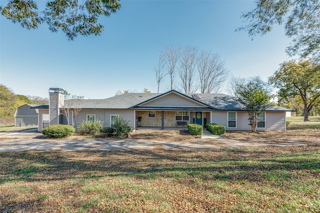 ranch-style house featuring a garage and a front yard