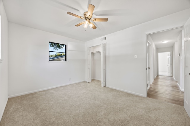 unfurnished bedroom with ceiling fan, a closet, and light colored carpet