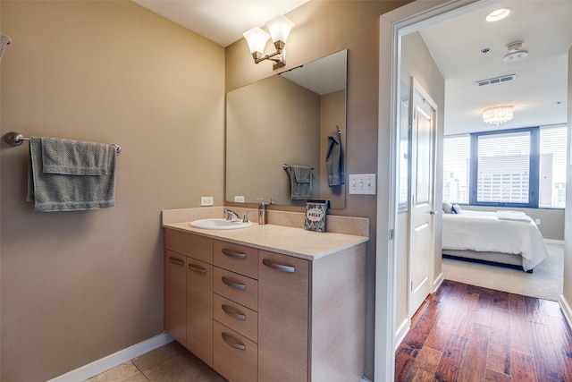 bathroom with hardwood / wood-style floors and vanity