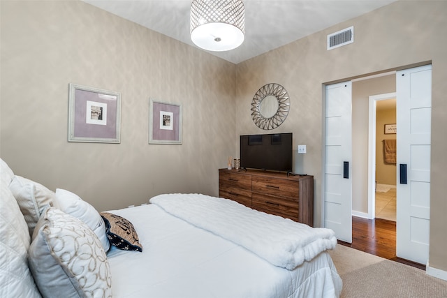 bedroom with hardwood / wood-style floors