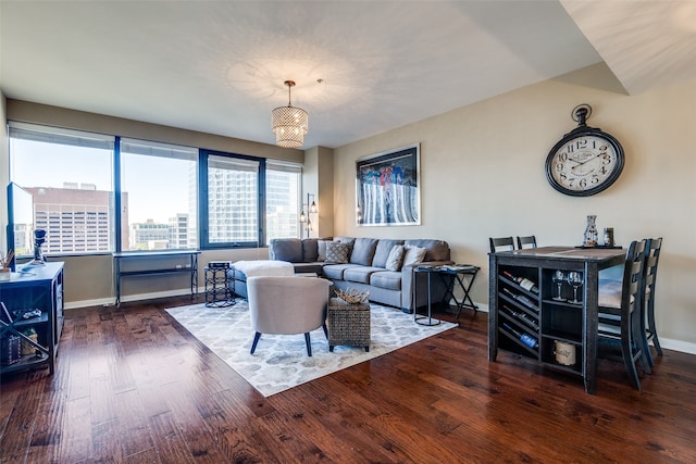 living room with a chandelier and dark hardwood / wood-style floors