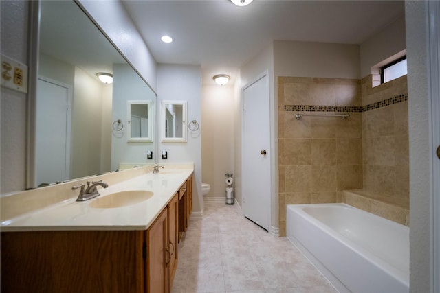 bathroom with tile patterned floors, toilet, vanity, and a tub to relax in