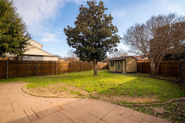 view of yard featuring a storage unit and a patio