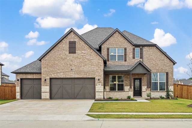 craftsman inspired home with a garage and a front yard