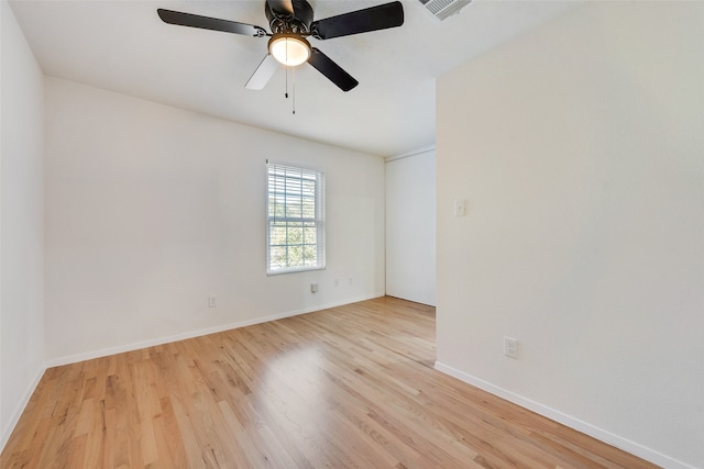 spare room with ceiling fan and light wood-type flooring