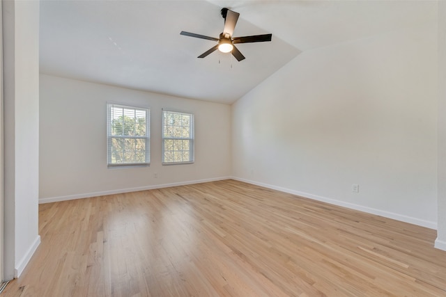 empty room with ceiling fan, light wood-type flooring, and vaulted ceiling