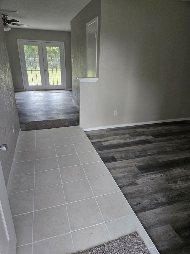 hallway with dark wood-type flooring and french doors