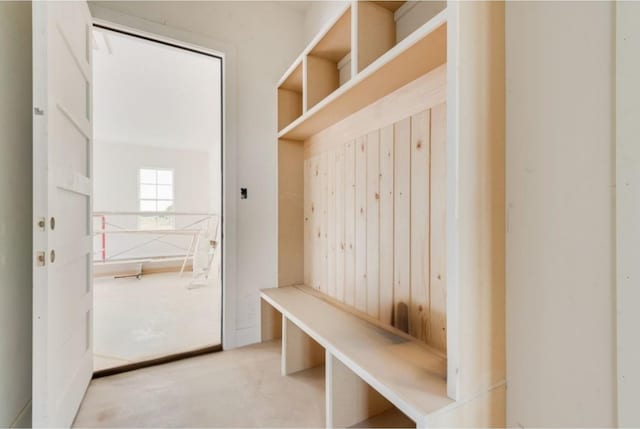 mudroom with wooden walls