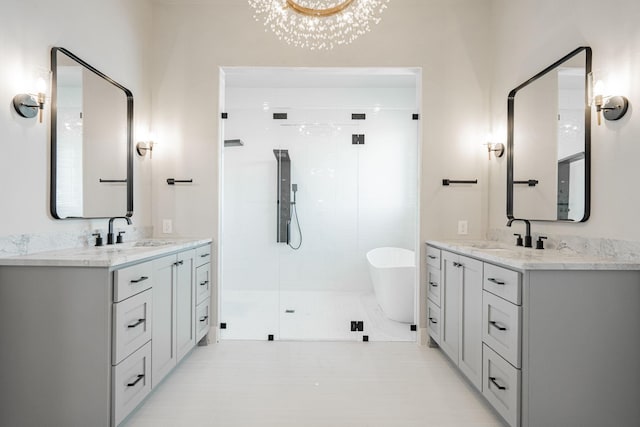 bathroom with vanity and separate shower and tub