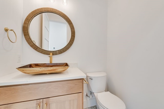 half bathroom with vanity and toilet