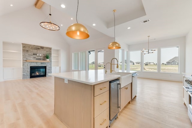 kitchen featuring modern cabinets, light brown cabinets, visible vents, and light wood-style floors