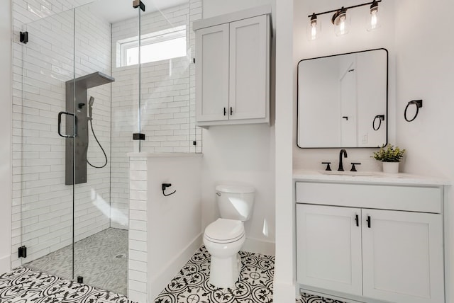 bathroom featuring a stall shower, baseboards, toilet, tile patterned flooring, and vanity