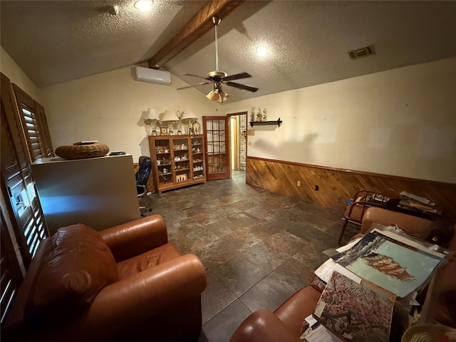 sitting room with visible vents, wooden walls, vaulted ceiling with beams, an AC wall unit, and wainscoting