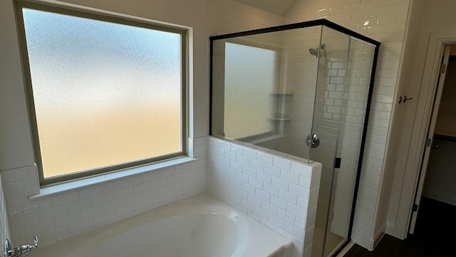 bathroom with separate shower and tub