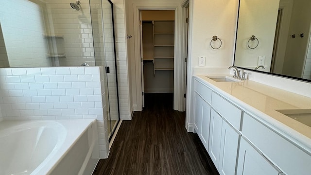 bathroom with vanity, wood-type flooring, and independent shower and bath