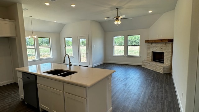 kitchen with dishwasher, an island with sink, white cabinetry, and sink