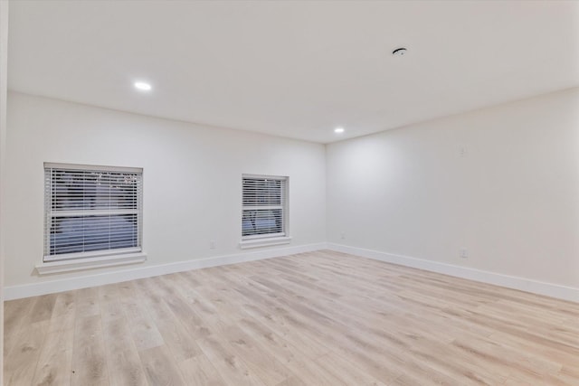 unfurnished room with light wood-type flooring