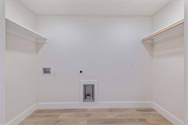 laundry area featuring electric dryer hookup, hookup for a washing machine, and hardwood / wood-style flooring