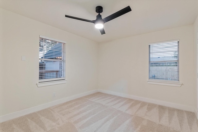 carpeted empty room featuring ceiling fan