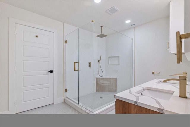 bathroom featuring vanity and a shower with door