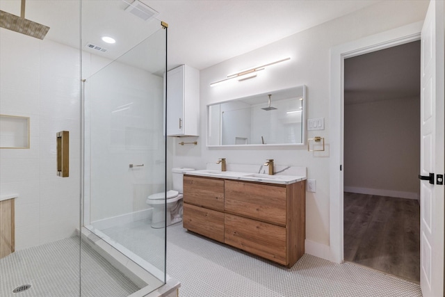 bathroom featuring hardwood / wood-style flooring, vanity, toilet, and a shower with shower door