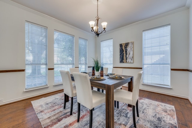 dining space with ornamental molding, dark hardwood / wood-style flooring, and a healthy amount of sunlight