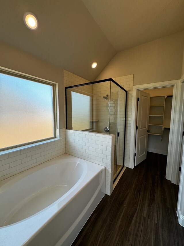 bathroom with separate shower and tub, wood-type flooring, and lofted ceiling